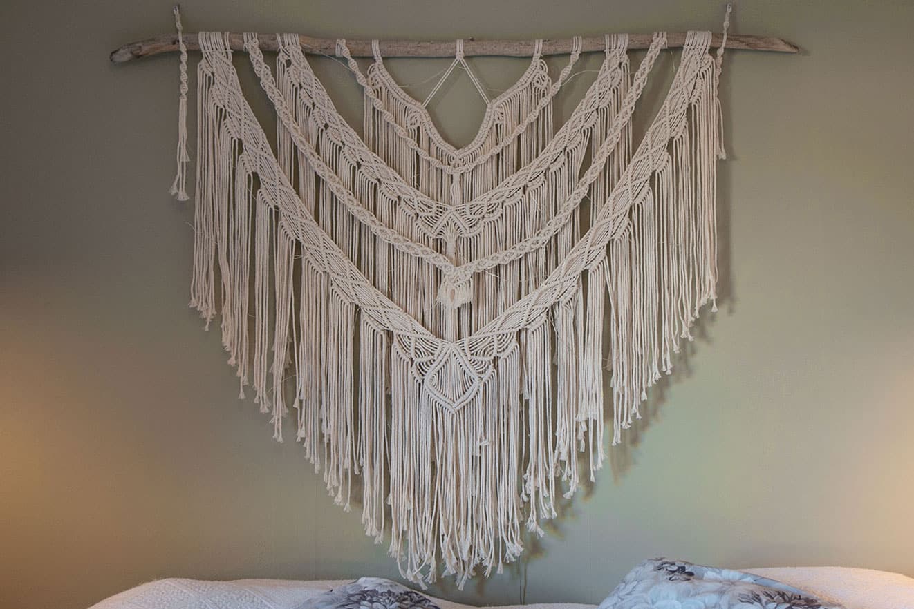 Macrame wall hanging decoration over bed